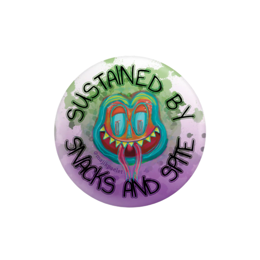 Brightly-colored frog-like original creature with it's tongue on a 2.25 inch round button that says "Sustained by Snacks and Spite" An original design by Majik Paelet (magic palette)